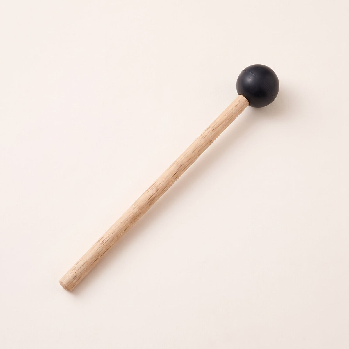 A mallet with a light handle and a round black head.