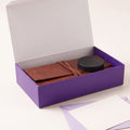 The gift box open with the set inside, a note card and envelope in front.