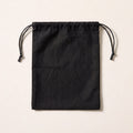 A plain black cloth drawstring bag with a black cord.