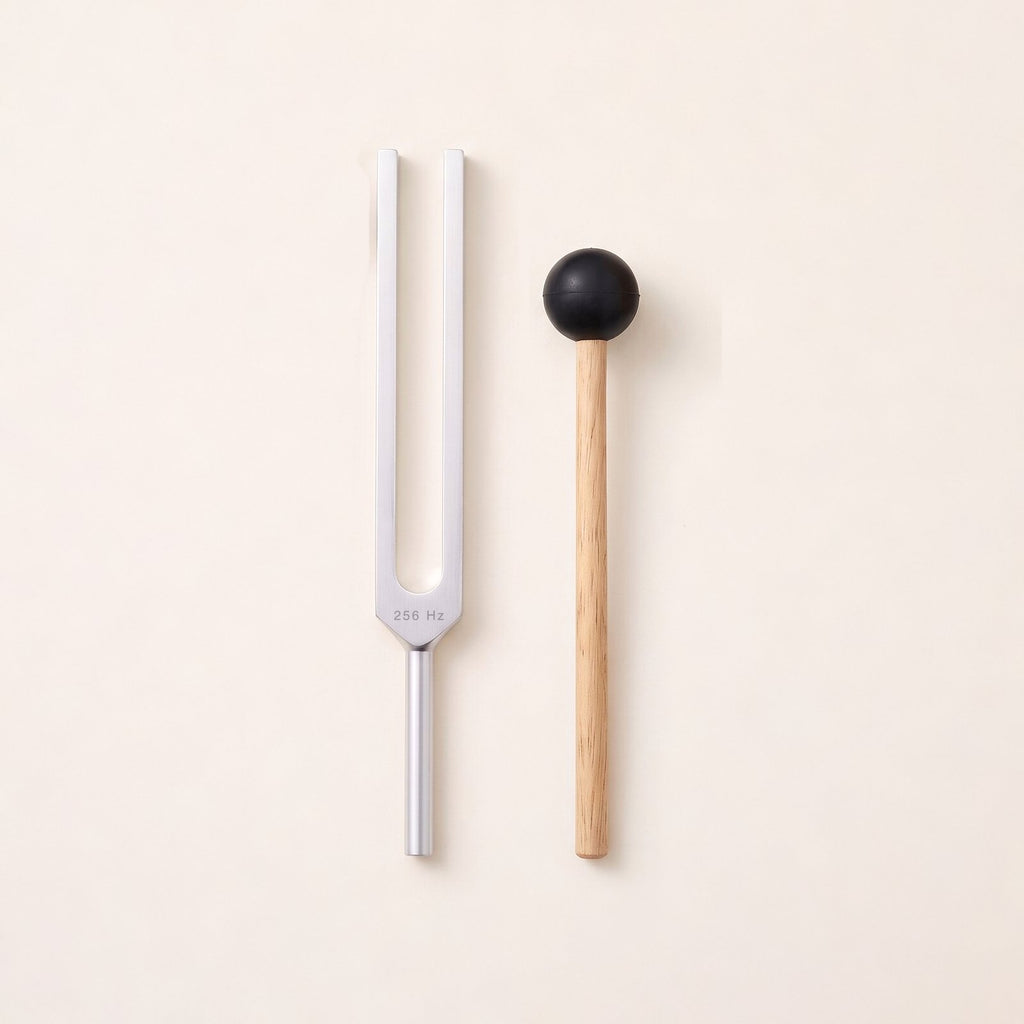 The 256 Hz tuning fork, a C, without weights, beside its wooden mallet.