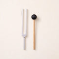 The 256 Hz tuning fork, a C, without weights, beside its wooden mallet.