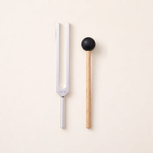 The 256 Hz tuning fork, a C, without weights, beside its wooden mallet.