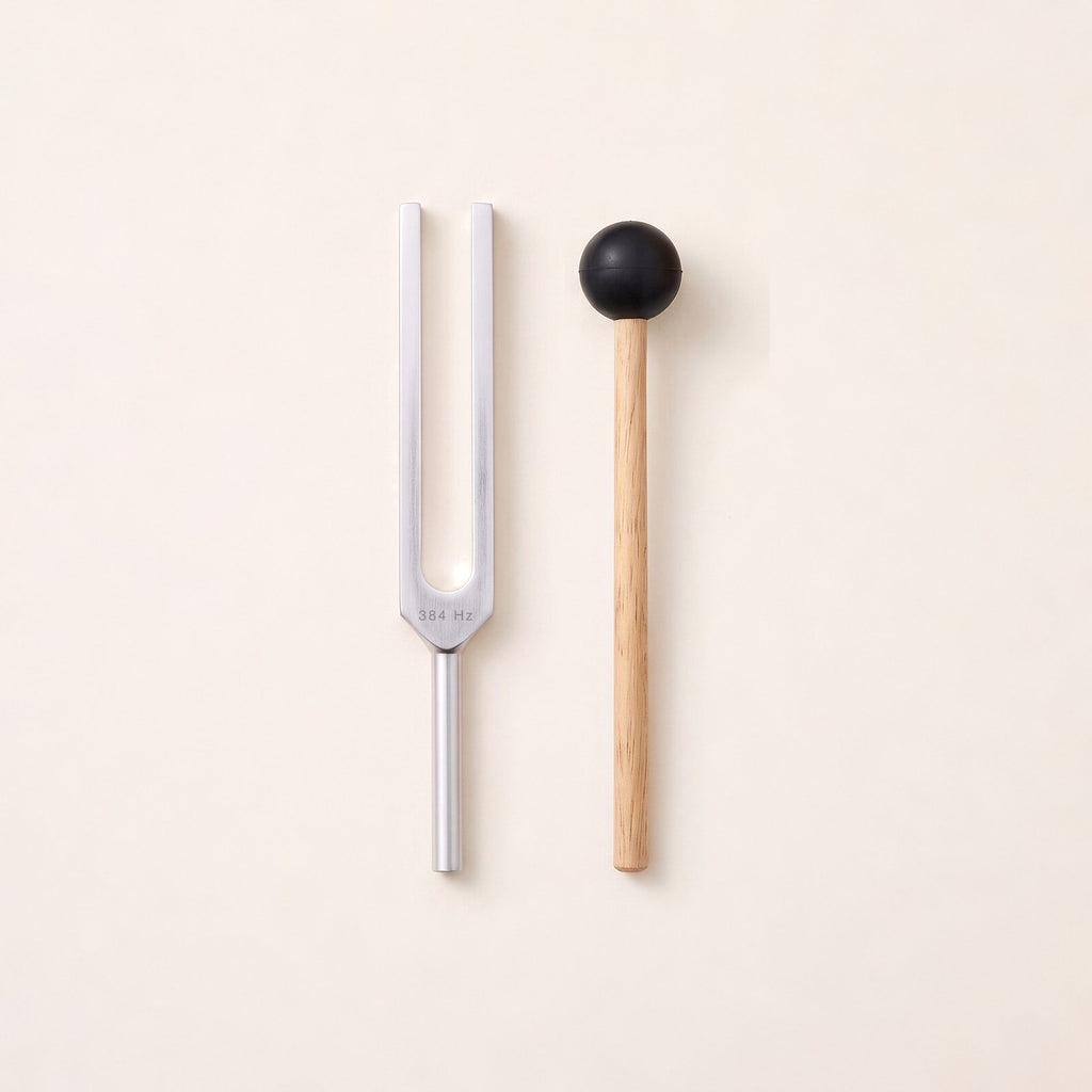 The 384 Hz tuning fork, a G, without weights, beside its wooden mallet.