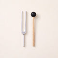 The 384 Hz tuning fork, a G, without weights, beside its wooden mallet.