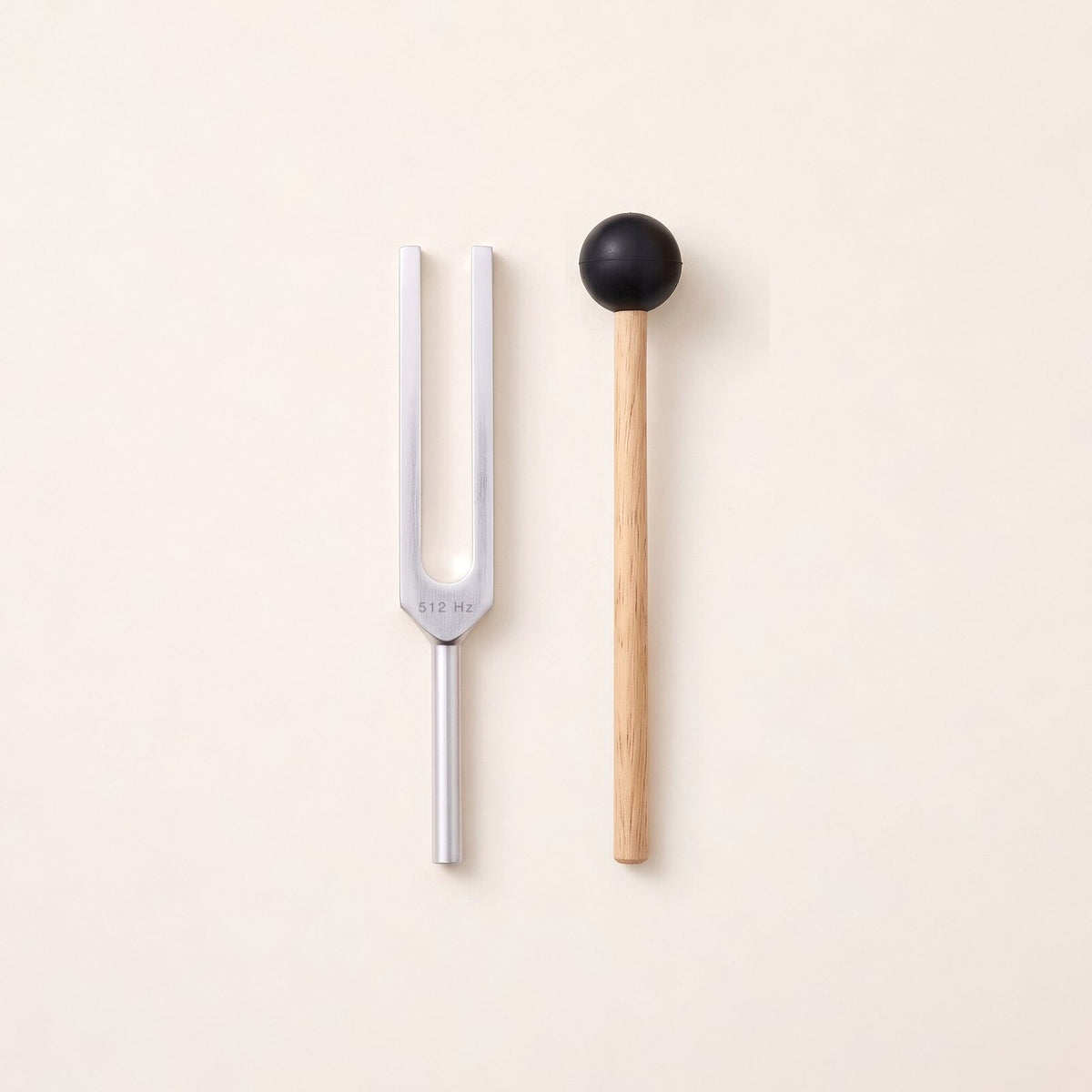 The 512 Hz tuning fork, a C, without weights, beside its wooden mallet.